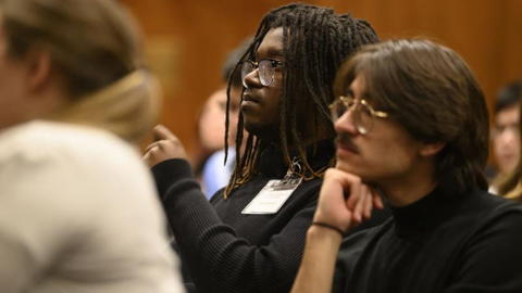 Students listen intently to a presentation.