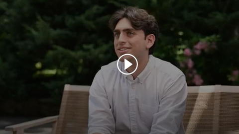 A screenshot of a video of a student speaking.