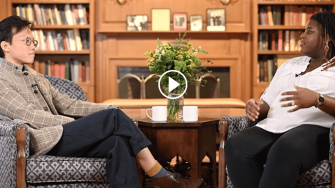 A screenshot of a video of two people speaking with each other.