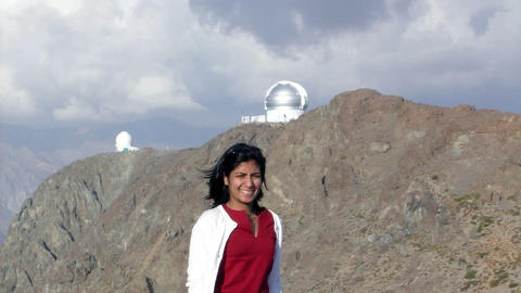 Photo of a young woman with a mountainous backdrop
