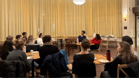 Two people speaking to a larger group of students
