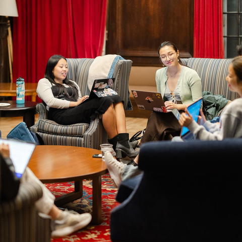 A group of students sitting on couches in a circle.