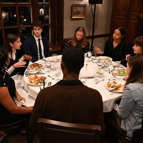 Students continue the conversation during a dinner with Professor Cikara as part of the Books Open, Gates Unbarred event series