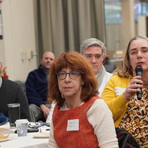 An event participant holds a microphone