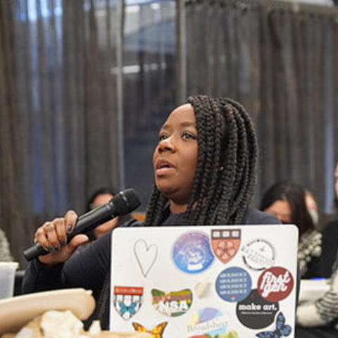 An event participant holds a microphone