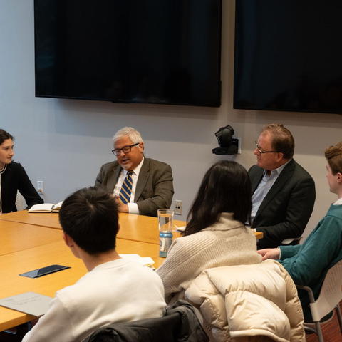 Student moderators Ari Kohn ’26 (far left) and Evan Doerr ’28 (far right, in green) moderate a conversation with AEI President Robert Doar and HLS Professor Jack Goldsmith