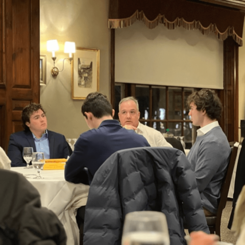 Students engage in conversation with Prof. Deloria during dinner at the Faculty Club