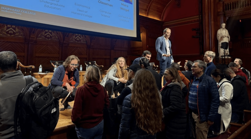 Students and families gather at the front of the stage