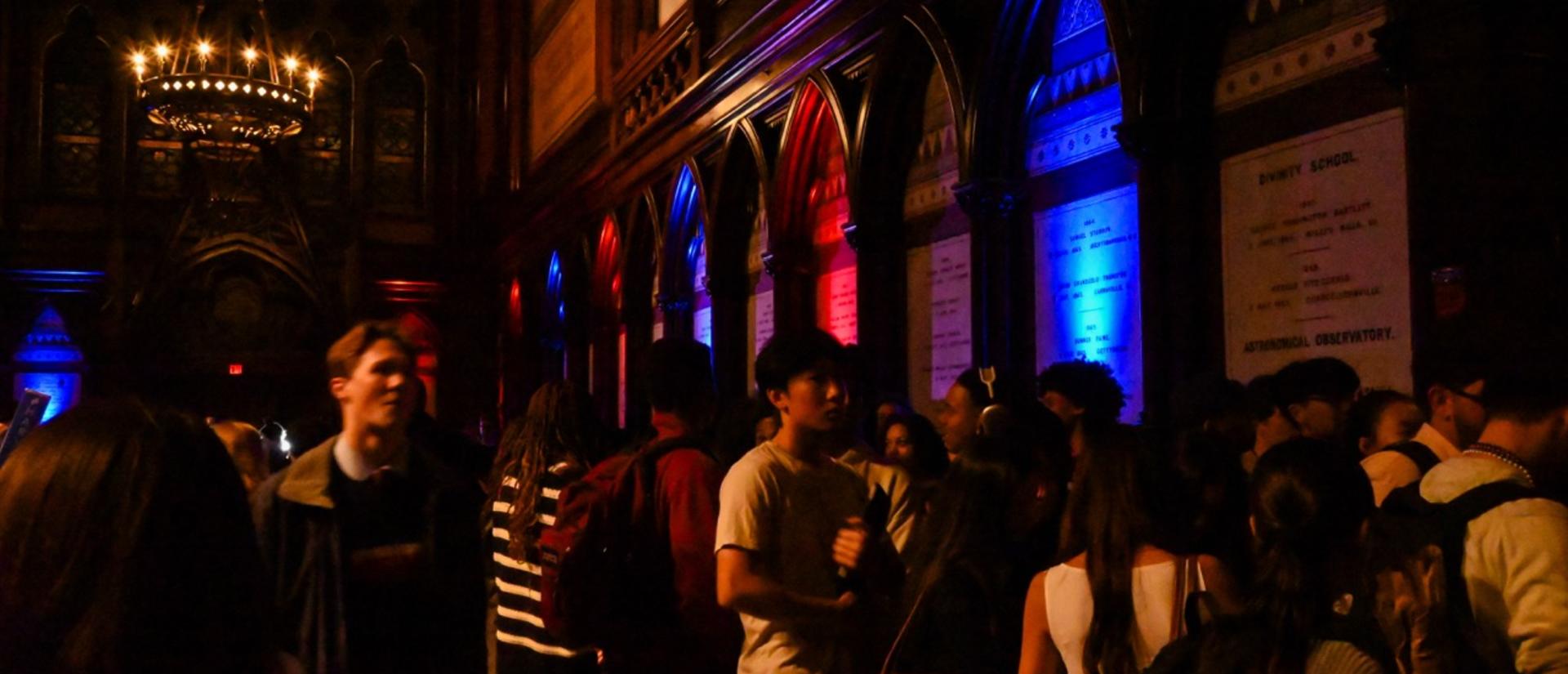 Sanders Theatre transept, illuminated in blue and red lights.