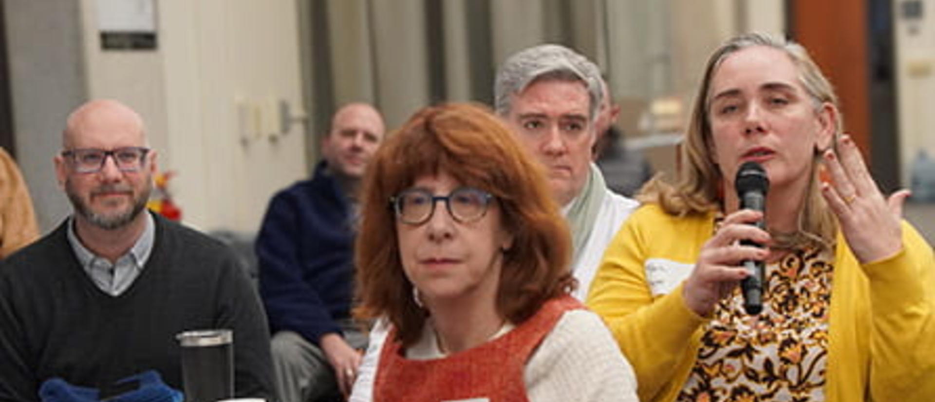 An event participant holds a microphone