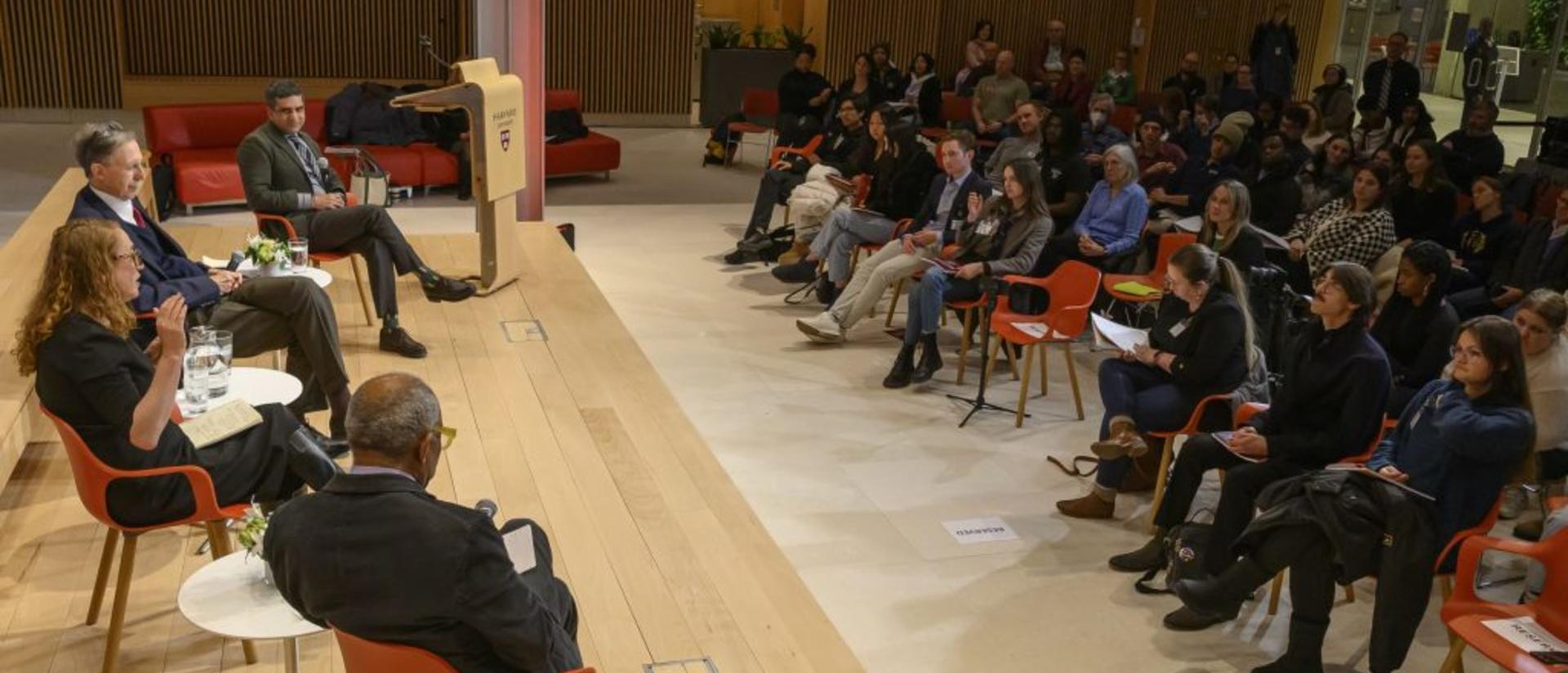 A panel sits in front of an audience