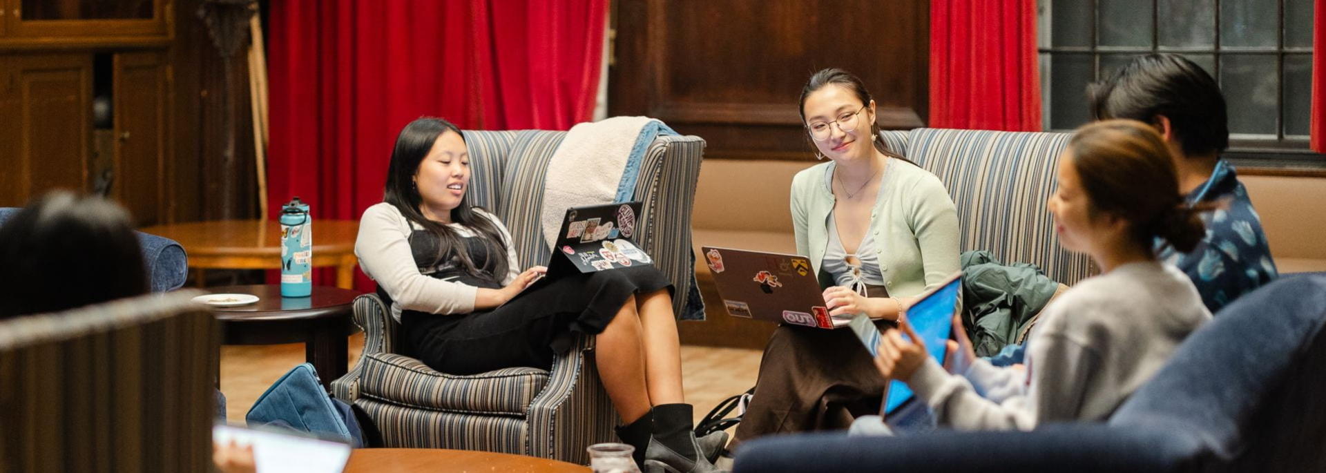 A group of students sitting on couches in a circle.