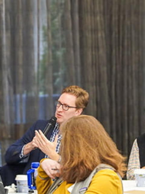 An event participant holds a microphone
