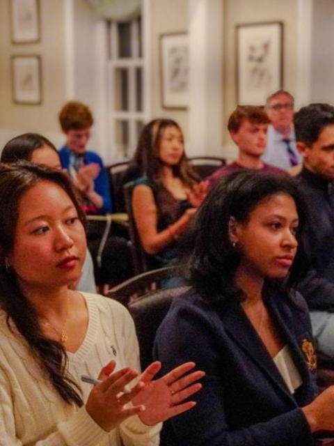 Harvard College student attendees listen to the faculty speakers as they discuss their research within the context of Harvard in the news.